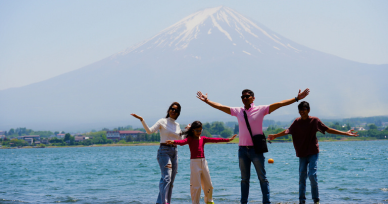Family posing in front of Mt. Fuji at the northern shore of Lake Kawaguchiko during a photo tour.