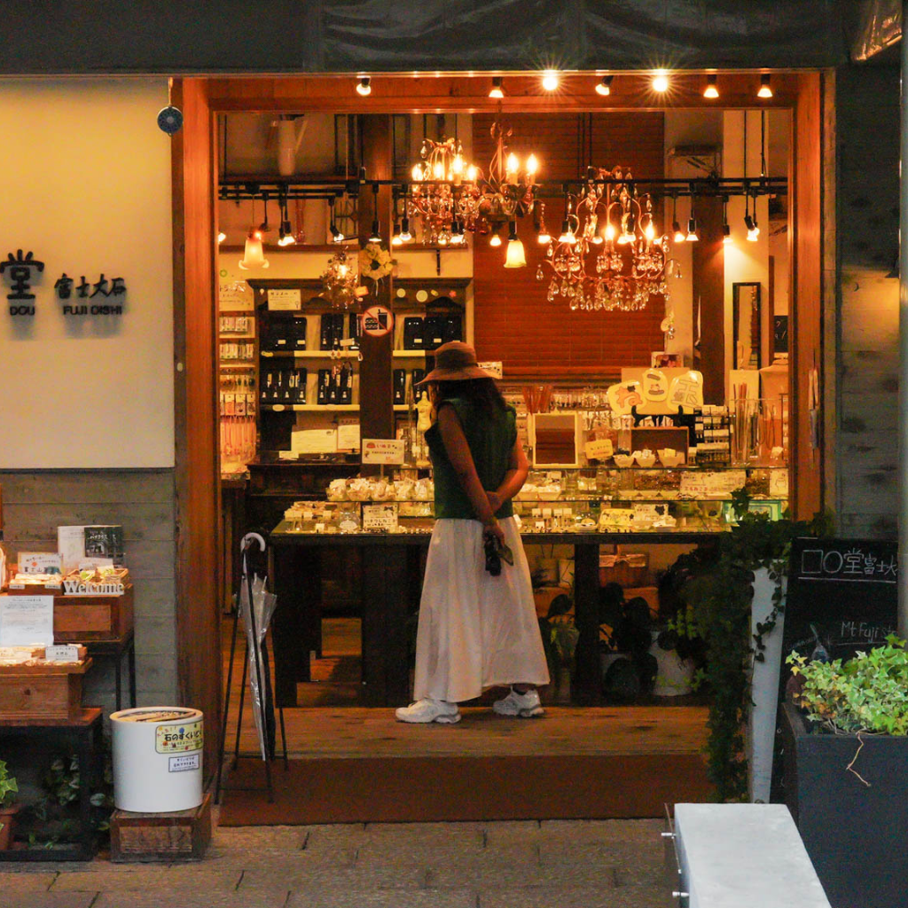 Tour guest browsing local goods inside Hana Terrace shop at Oishi Park near Mt. Fuji.