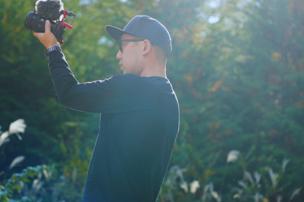 Photographer taking photos during a Mt. Fuji private tour, with camera in hand and guests nearby.