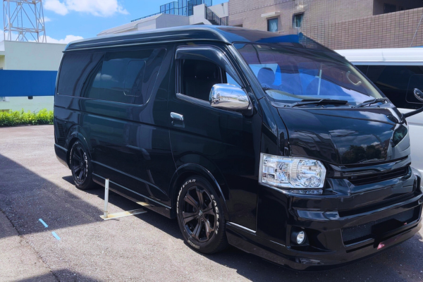 Private tour vehicle parked near Mt. Fuji, used for transporting guests during a photo tour.