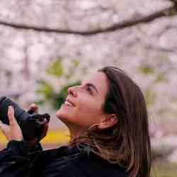 Tour guests enjoying a lakeside park near Lake Kawaguchiko with Mt. Fuji in the background.
