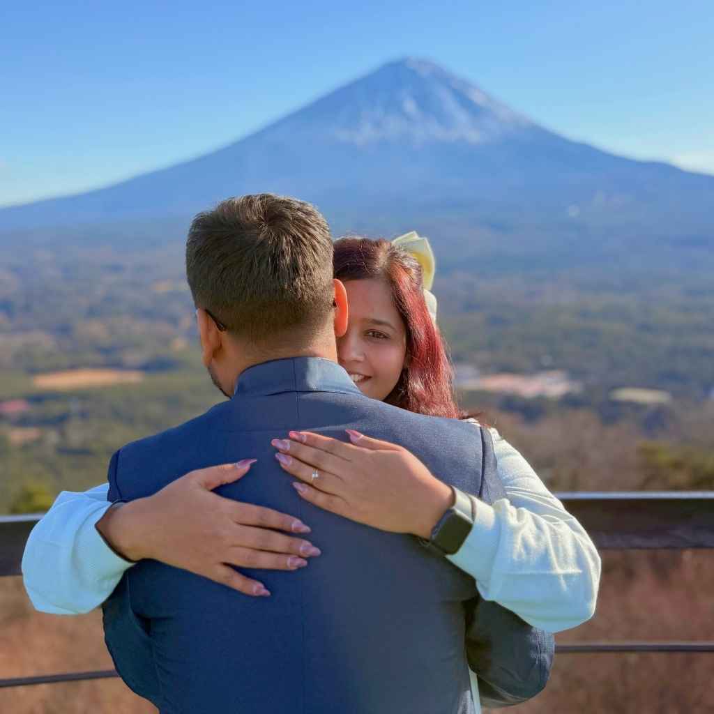 Couple embracing with Mt. Fuji in the background during a private photo tour in Yamanashi, Japan