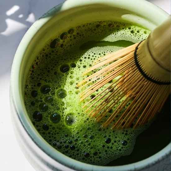 Traditional Japanese matcha tea prepared with a bamboo whisk