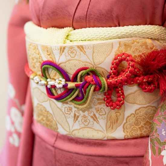 Detailed traditional Japanese kimono obi with decorative accessories