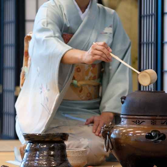 Traditional Japanese tea ceremony preparation with a bamboo ladle and kettle