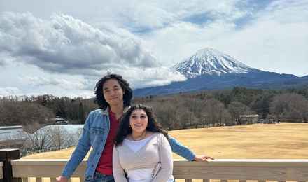Couple sitting on the grass and looking at Mt. Fuji at Narusawa Ikiiki Square
