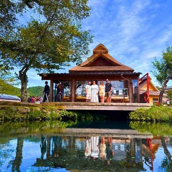 Traditional Japanese house reflected in a clear pond at Oshino Hakkai